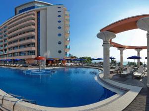 a swimming pool in front of a hotel at Astera Hotel & Spa with FREE PRIVATE BEACH in Golden Sands
