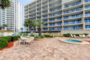 a patio with a table and chairs in front of a building at Sterling Sands 803 Destin (Condo) in Destin