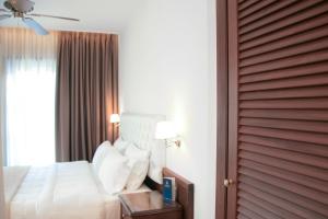 a hotel room with a bed and a window at Armata Boutique Hotel in Spetses