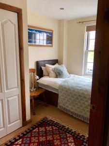 a bedroom with a bed and a window at Castle View Place in Dornoch