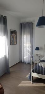 a bedroom with a bed and a table and a window at CASA FLORA in Palermo