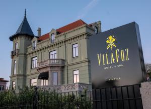 a building with a sign in front of it at Vila Foz Hotel & SPA - member of Design Hotels in Porto