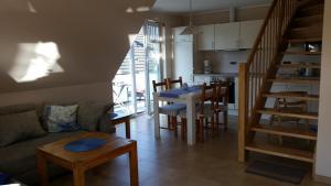 a living room with a couch and a table at Ferienwohnungen Meeresgruss in Sankt Peter-Ording