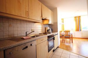 a kitchen with a sink and a stove top oven at Bauernhof Rickerts in Vollerwiek