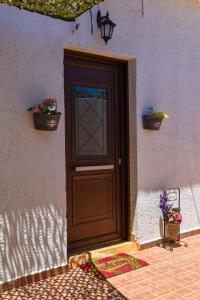 a brown door on the side of a house at Afrodites Residence Triopetra in Triopetra