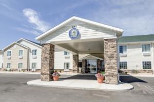 a building with a clock on the front of it at Cobblestone Inn and Suites - Eaton in Eaton