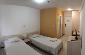 Tempat tidur dalam kamar di Silva Hospedagem