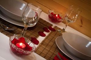 a table with two wine glasses and a candle on it at Campamento Turístico Brandoñas in Brandoñas +26 photos