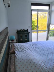 a bedroom with a bed and a large window at Vue exceptionnelle in Mandelieu-la-Napoule +26 photos
