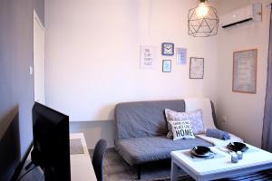 a living room with a couch and a table at Cozy and Modern in Komotini