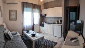 a living room with a couch and a table at Cozy and Modern in Komotini