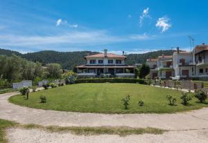 a large house with a large lawn in front of it at Vourvourou Villa Mare Verde by Luxlikehome in Vourvourou