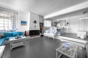 a living room with a blue couch and a table at Vourvourou Villa Mare Verde by Luxlikehome in Vourvourou