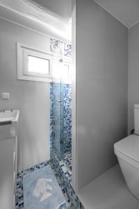 a bathroom with a toilet and a glass shower at Vourvourou Villa Mare Verde by Luxlikehome in Vourvourou +33 photos