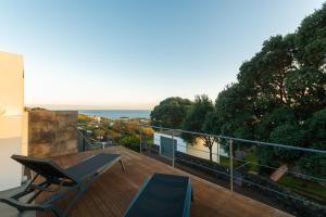 a balcony with a view of the ocean at H. S. Caloura in Lagoa