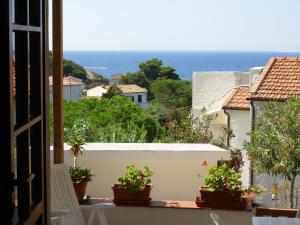 a view of the ocean from the balcony of a house at Appartamento Il Nespolo in Pomonte