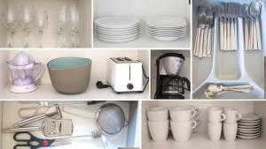 un armario blanco lleno de platos, tazas y utensilios en Ca la iaia - Turisme familiar, en Amer