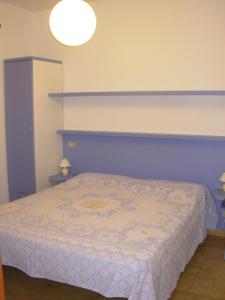 เตียงในห้องที่ Appartamento Il Nespolo
