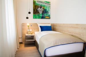 Postel nebo postele na pokoji v ubytování Hotel Atlas Leipzig