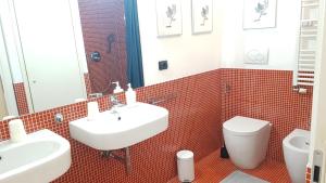 un bagno con un lavandino bianco e un water di Casa Maltese a Torino Altre 13 foto