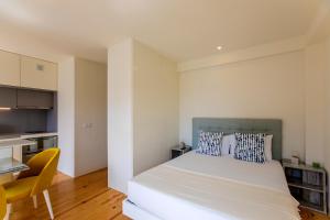 En eller flere senge i et værelse på Casa São Lázaro