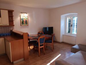 a kitchen and dining room with a table and chairs at Apartments Jerko in Primošten