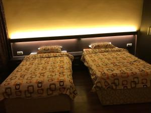 two beds sitting next to each other in a room at Център in Pleven