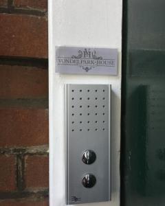 a metal box with a sign on a brick wall at Vondelpark House B&B in Amsterdam