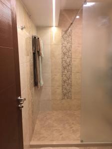 a shower with a glass door in a bathroom at Център in Pleven