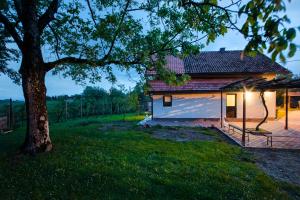 a house with a red roof and a tree at Holiday Home Dandelion with Hot Tub & Sauna in Cetingrad