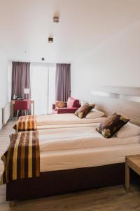 a bedroom with two large beds with pillows on them at Hotel Duus by Keflavik Airport in Keflavík