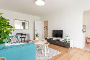 Televízia a/alebo spoločenská miestnosť v ubytovaní Hendrix Bridge Apartment 2