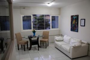 a living room with a couch and a table at Casa da Esquina Pousada in Recife