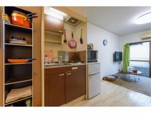 a small kitchen with a sink and a stove at Sora / Vacation STAY 1124 in Sakai