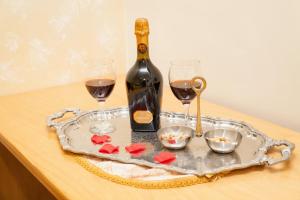 a bottle of wine and two glasses on a table at Bed & Breakfast Santa Caterina in Ercolano
