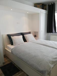 a bedroom with a bed with two pillows on it at appartement oostende vlak aan zee in Ostend