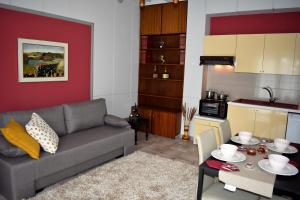 a living room with a couch and a table at Cozy apartments in Komotini