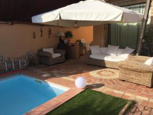 - une piscine avec un parasol et un ballon de blanc dans l'établissement Casa Gle, à SantʼAndrea