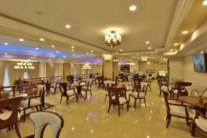 a restaurant with tables and chairs in a room at Sapphire Addis in Addis Ababa
