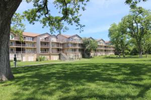 a large building in a park with a green lawn at Rose' River Retreat in New Braunfels