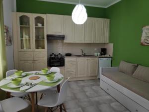 a kitchen with a table and a couch in a room at Cozy apartments in Komotini
