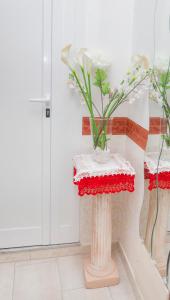 a room with two tables with flowers on them at Bed & Breakfast Santa Caterina in Ercolano