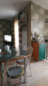 a kitchen with a table and chairs and a refrigerator at Apartmán Romance in Komárno