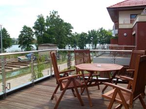 a wooden deck with a table and chairs on a balcony at APARTAMENT JULIA in Ostróda