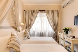 Postel nebo postele na pokoji v ubytování Casa Mia Vaticano Guest House