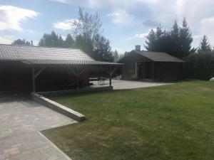 a yard with a house and a pavilion at Domek letniskowy in Augustów