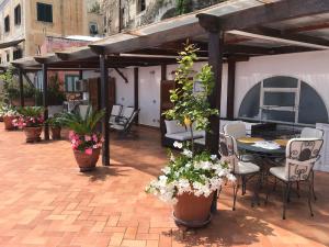 
a patio area with tables, chairs and umbrellas at Suite Antimo Original in Positano
