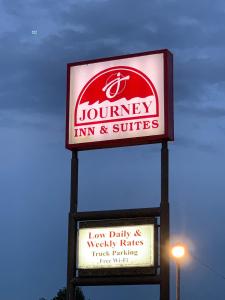 a sign for a louney inn and suites on a pole at Journey Inn Marion in Marion
