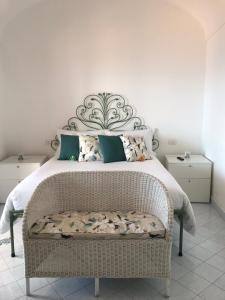 a bedroom with a large bed with a large headboard at Suite Antimo - Casa Scibetta in Positano
