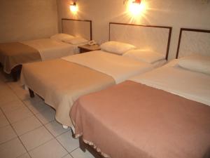 A bed or beds in a room at Hotel Kuraica